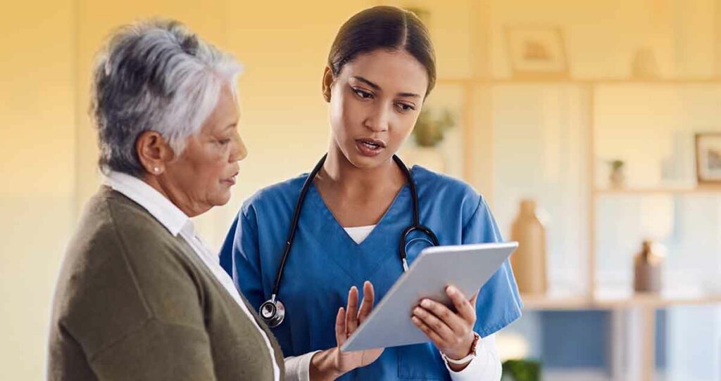 Taking her through her diagnosis. a young doctor using a digital tablet during a consultation with a senior woman