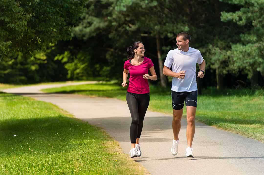 Photo of man and woman jogging in a park