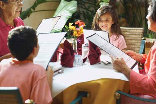 Photo of family dining out grandparents and grand children