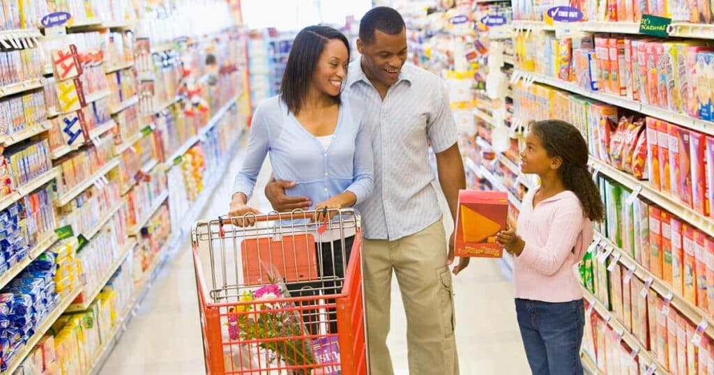 Family shopping in the grocery aisle looking for affordable allergen-free foods.