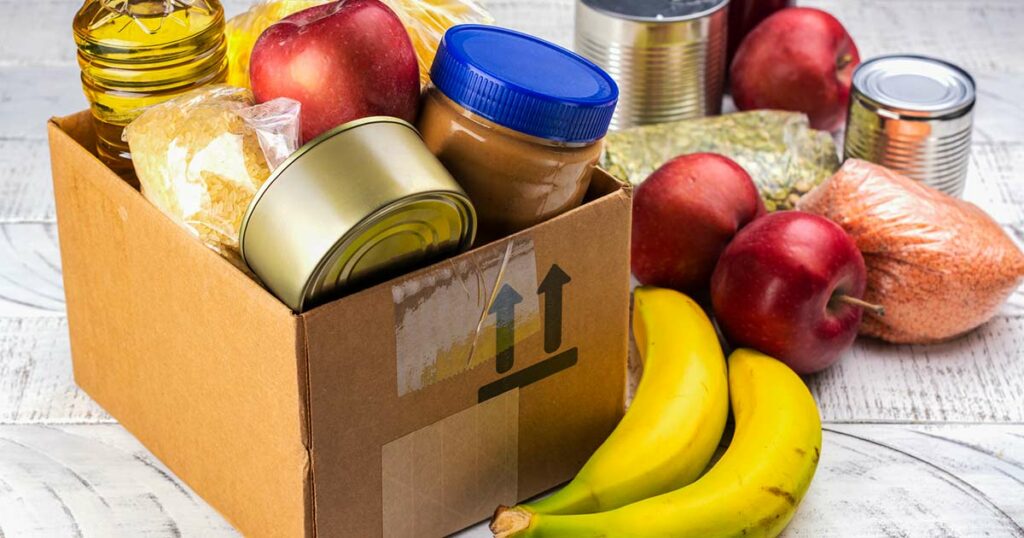 Unlabeled cardboard box of food from a food pantry.