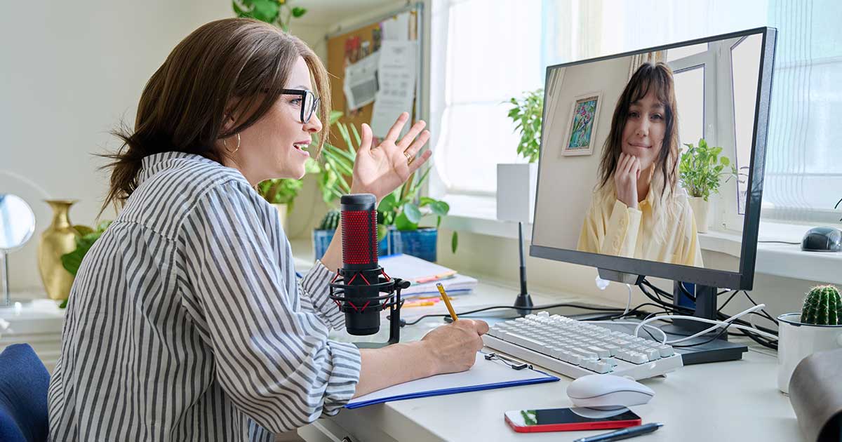 Woman asthma coach talking online, via video, to woman with asthma.