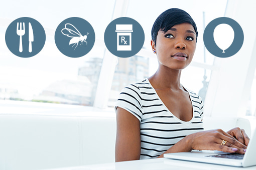 Photo of woman at a computer with icons representing anaphylaxis triggers