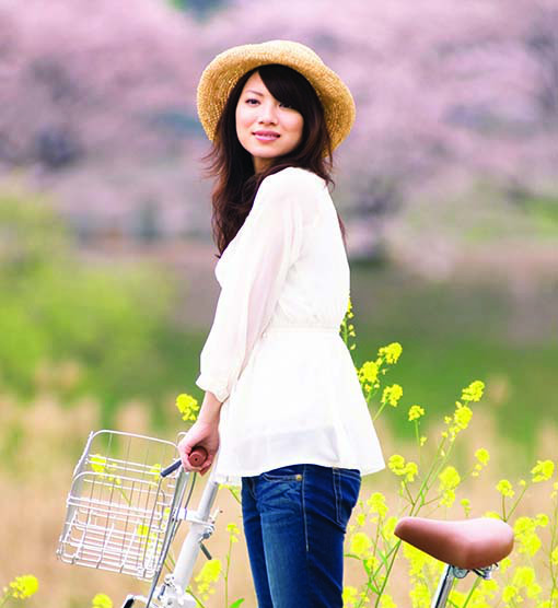 photo of woman on a bike ride through the spring country side