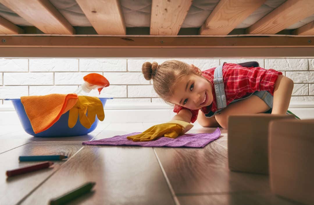 Young girl helping to clean the house. She