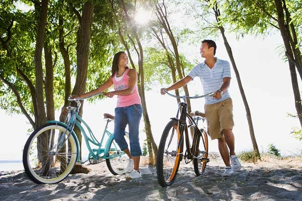 Couple with bicycles in the park. They