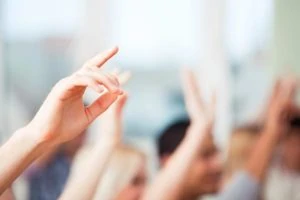 Image of hands up in the air volunteering