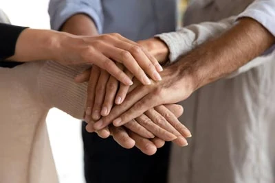 People holding hands in a stick signifying leadership