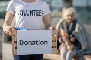 Image of volunteer woman with donation box